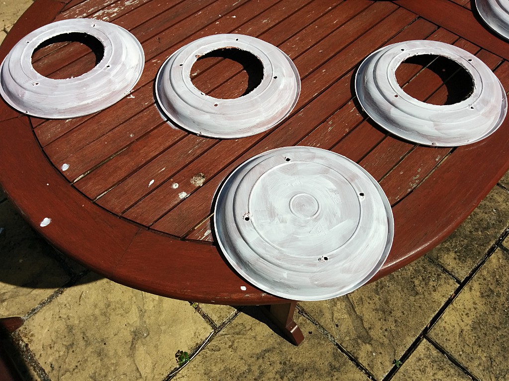 Painted saucers with drainage holes